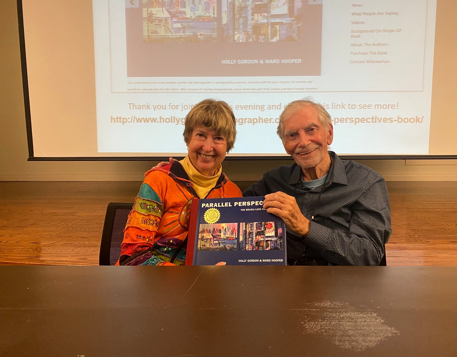 Holly Gordon and Ward Hooper show off their book “Parallel Perspectives: The Brush Lens Collaboration,” after their talk and book signing on Sept. 21 at the Bay Shore-Brightwaters Library.
